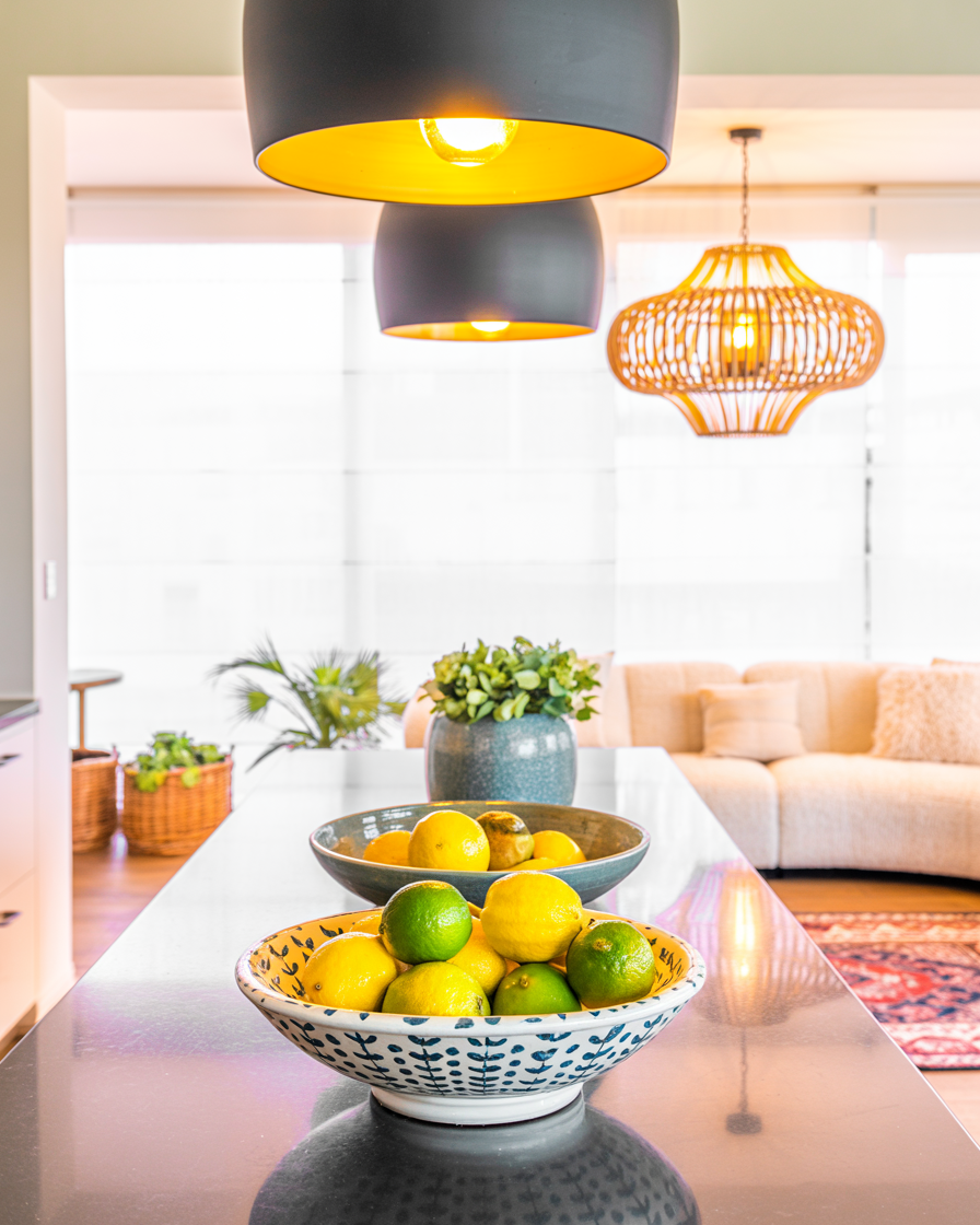 Coordinated lighting across lake house living and kitchen zones