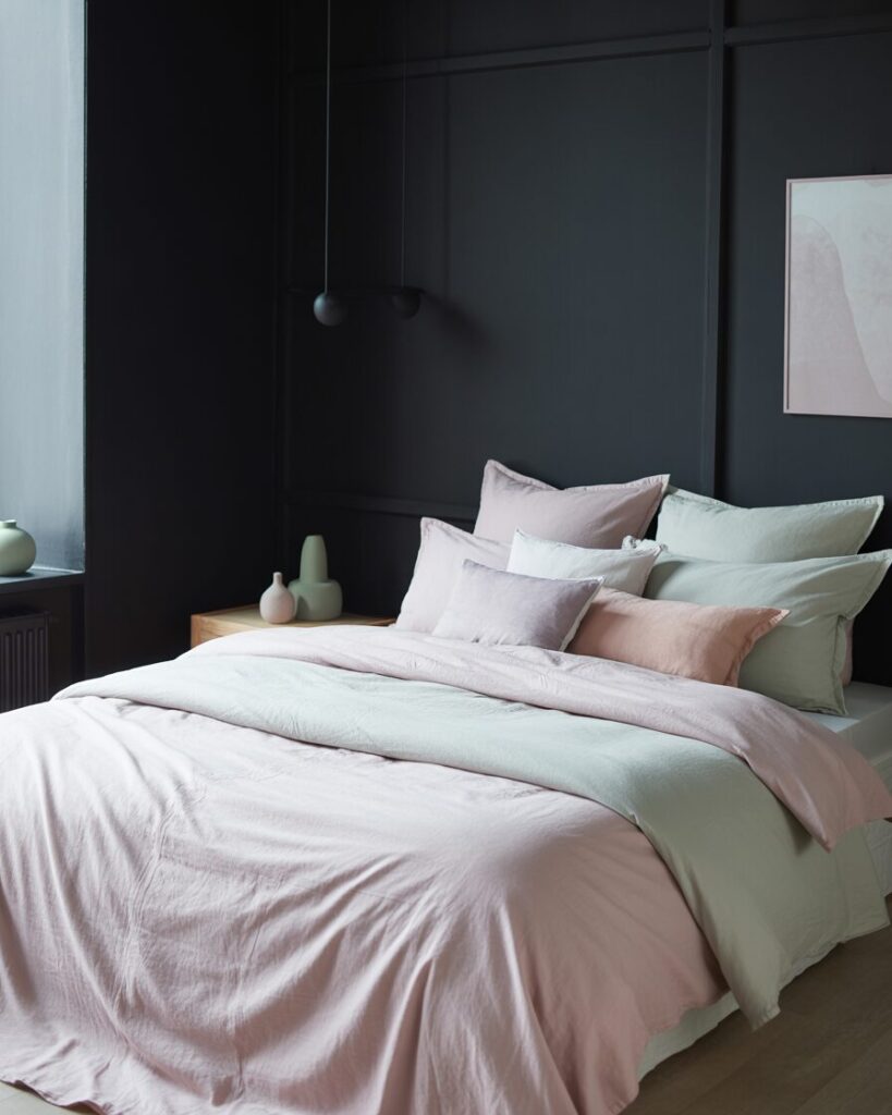 A luxurious black bedroom with stunning gold accents and elegant lighting.
